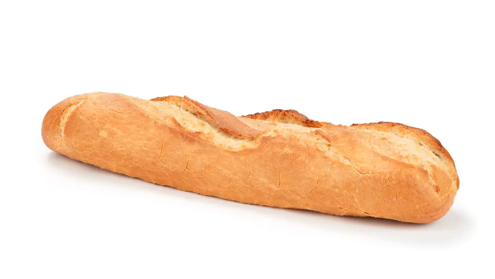 A long loaf of bread on top of a white surface.