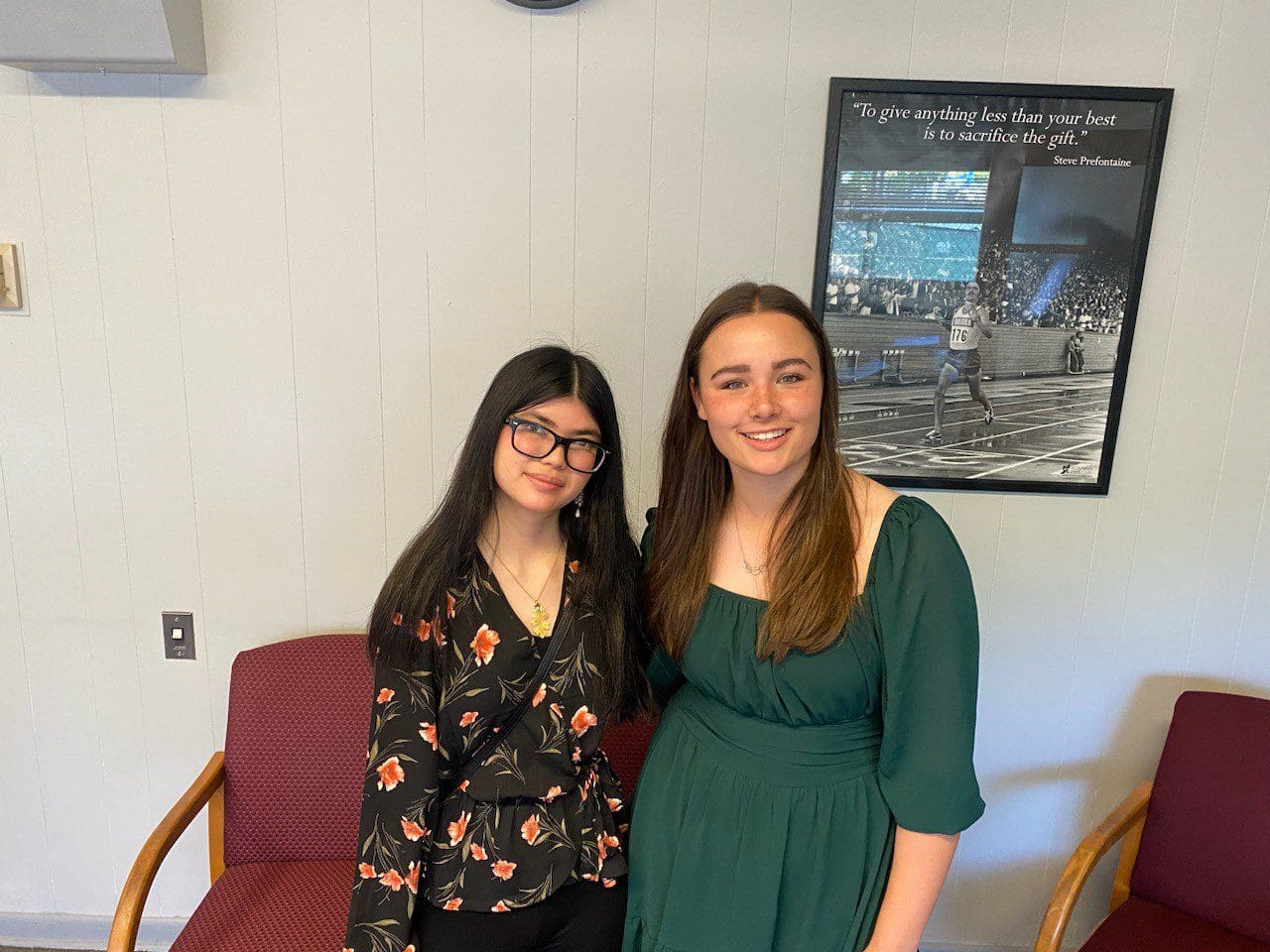 Two women standing next to each other in a room.