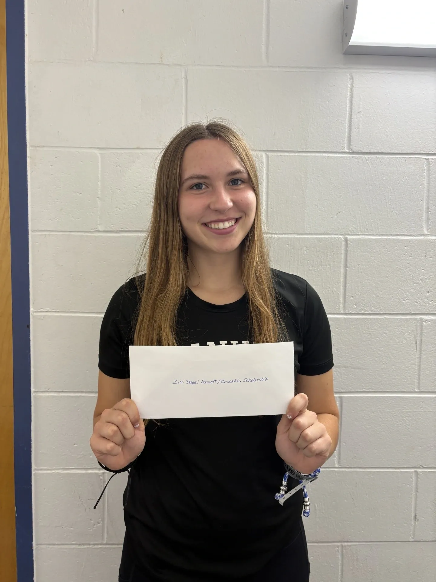 Ashley Wain photo Zimi scholarship 2025 NT Young woman holding papers.