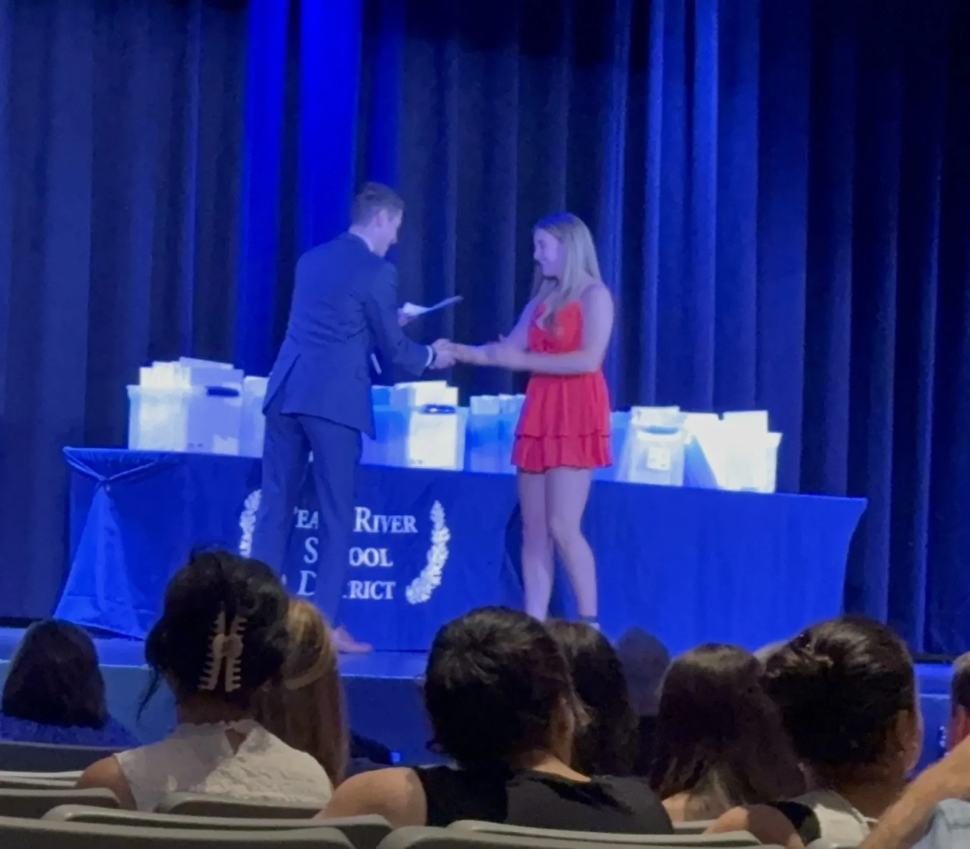 Kacey Pritts PR Zimi Scholarship 2025 A man and woman are shaking hands on stage.
